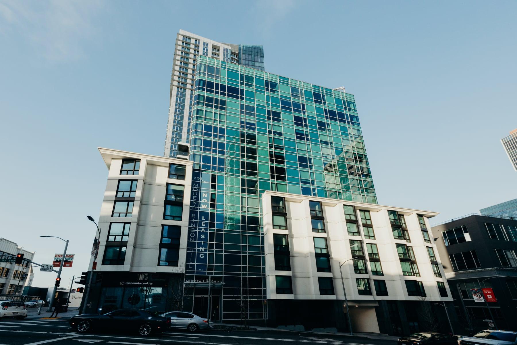 390 1st Street (Modera Rincon Hill) in San Francisco, a tower with a teal glass curtain wall above a white lower building