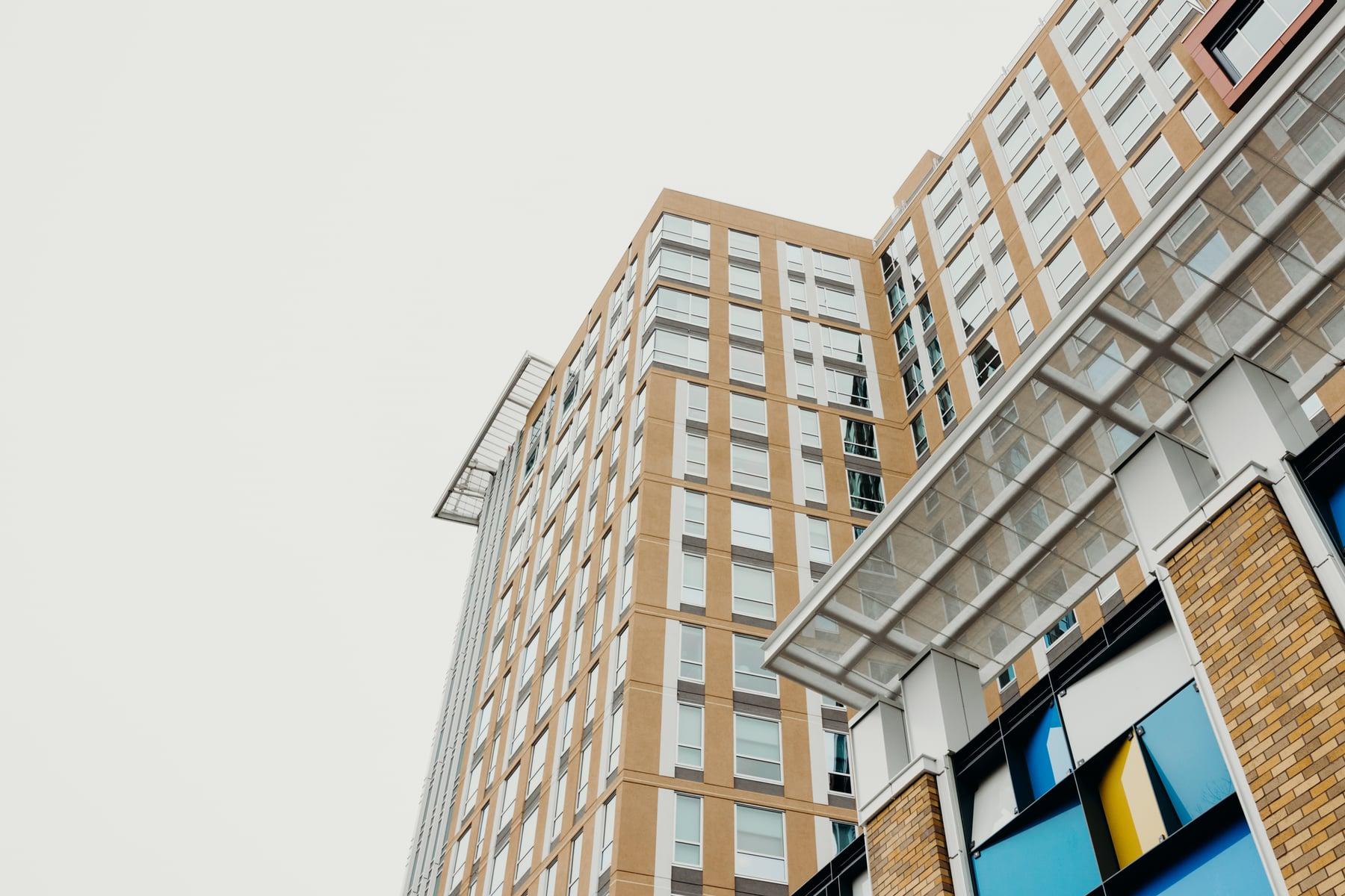 Glass canopy over a corner entrance at the Residence Inn, with the tower rising behind
