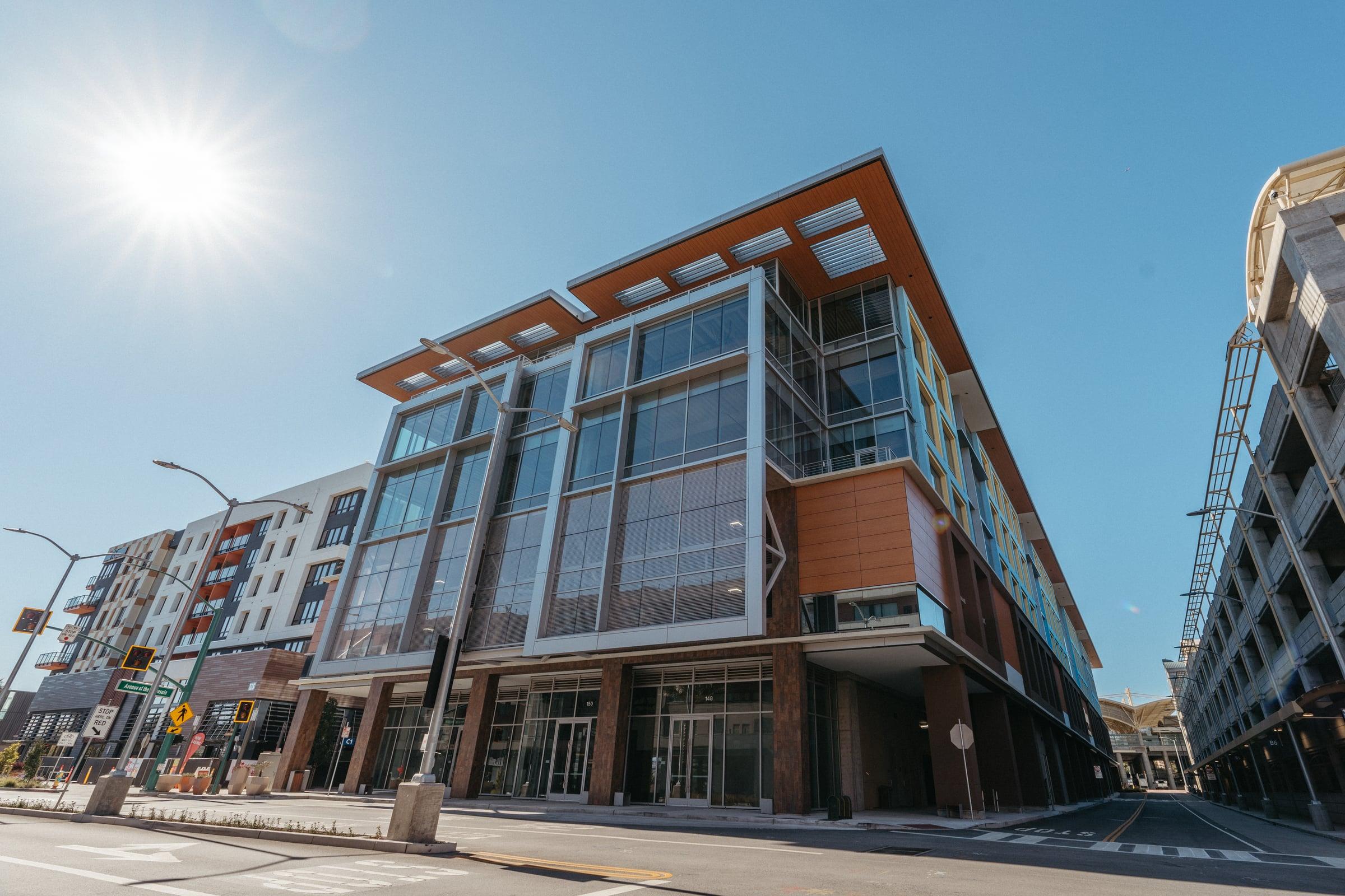 Mixed-use building exterior with glazing and metal panel accents in Millbrae, CA