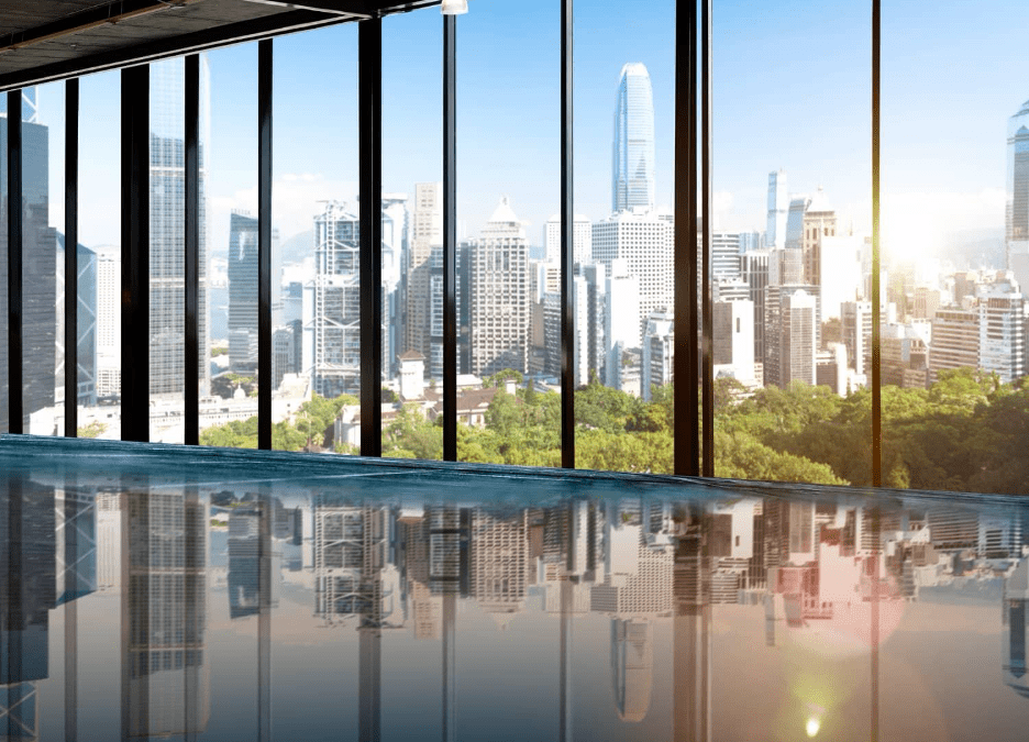 Interior view of a room with floor-to-ceiling glazing, flooding the space with natural light and offering expansive views of the outdoors.