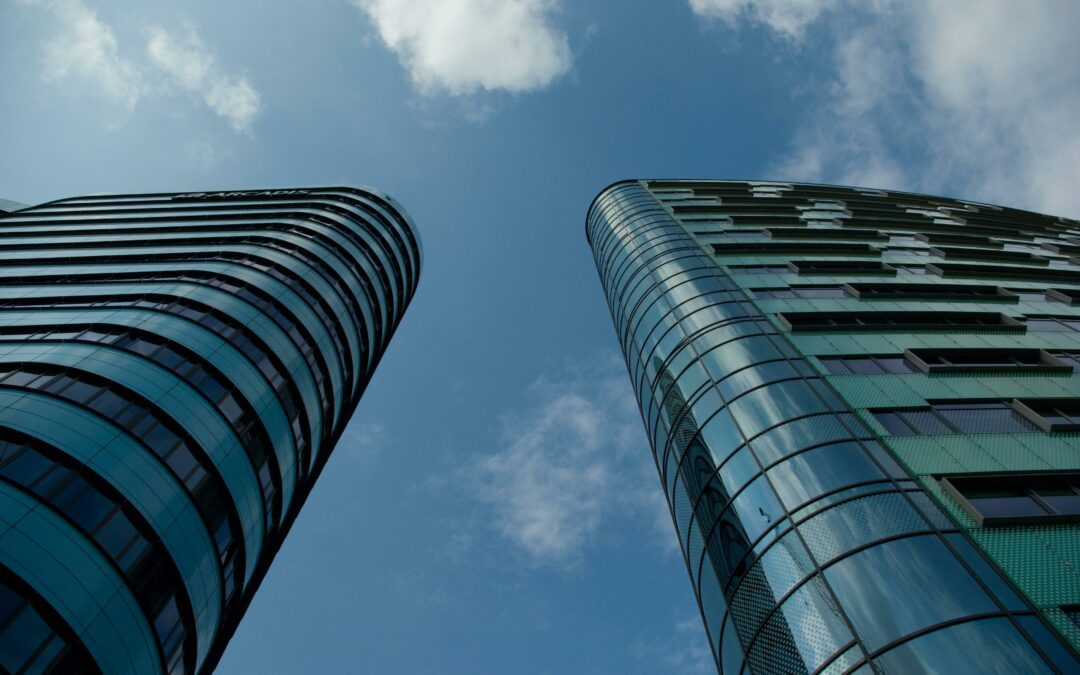 Two buildings with double-glazed windows showcasing the benefits of glazing maintenance for energy efficiency and durability.